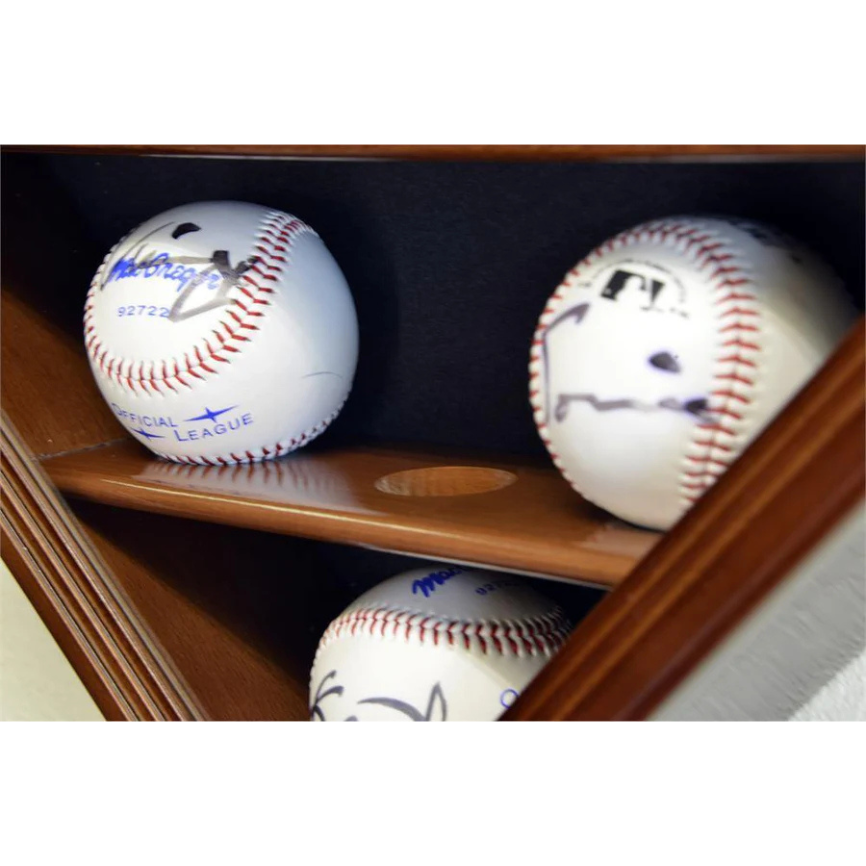 Three baseballs with autographs on a wooden shelf. Baseball Display Case Holder. 3 signed baseball game balls arranged in a grid pattern.