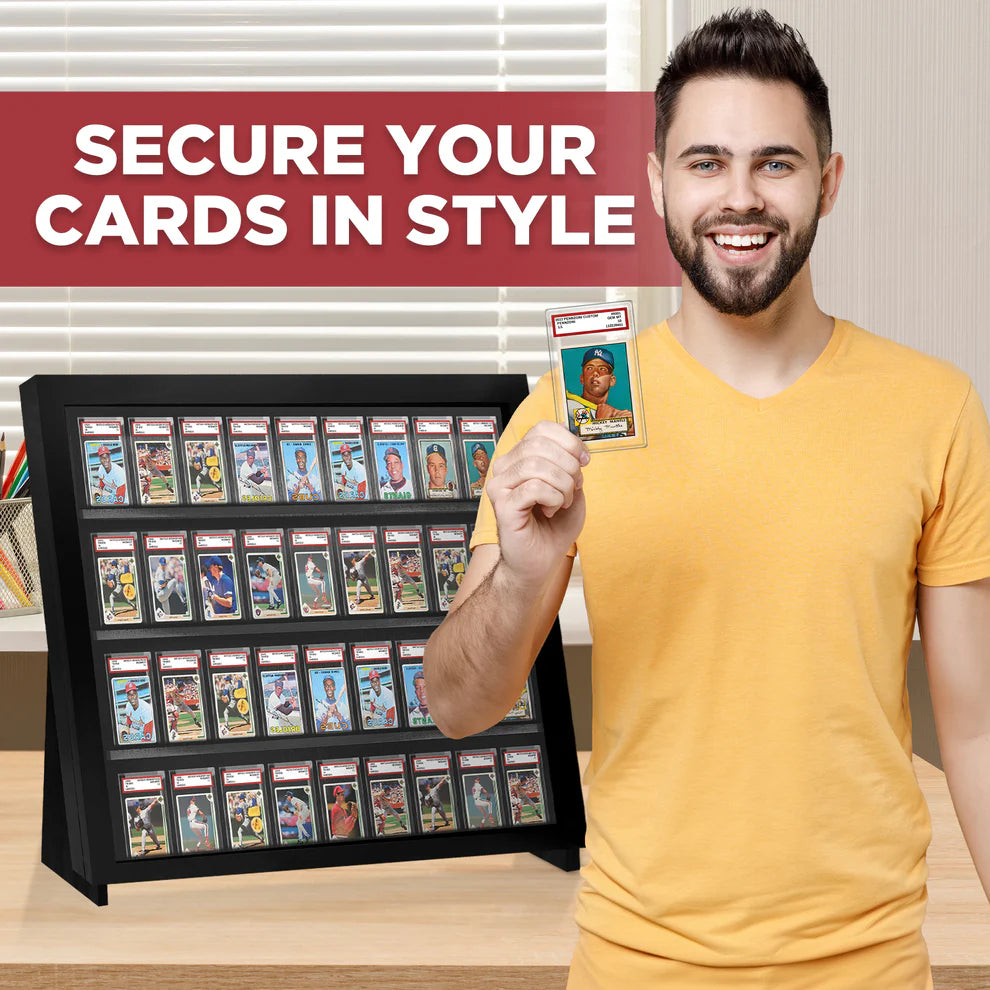 Man holding a trading card display case with a single card, smiling.