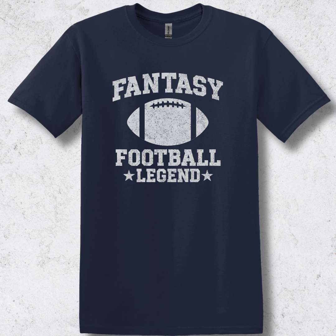 Navy blue t-shirt with 'Fantasy Football Legend' text and football graphic on a textured white background