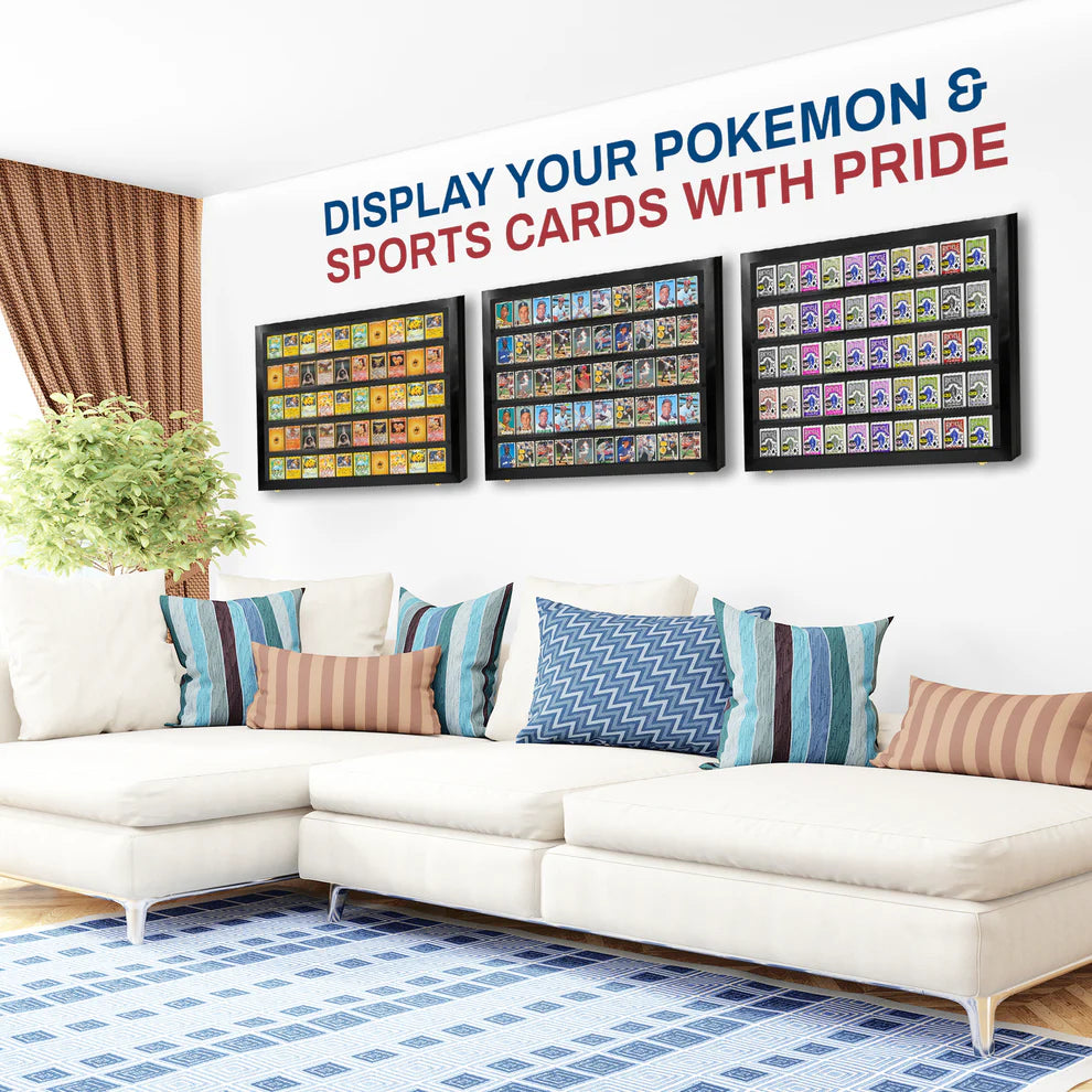 Framed collectible cards displayed on a wall above a white sofa with colorful pillows.