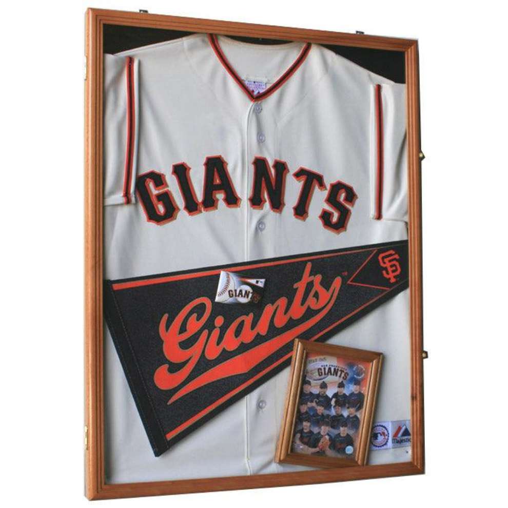 Baseball jersey with 'Giants' branding in a display case.