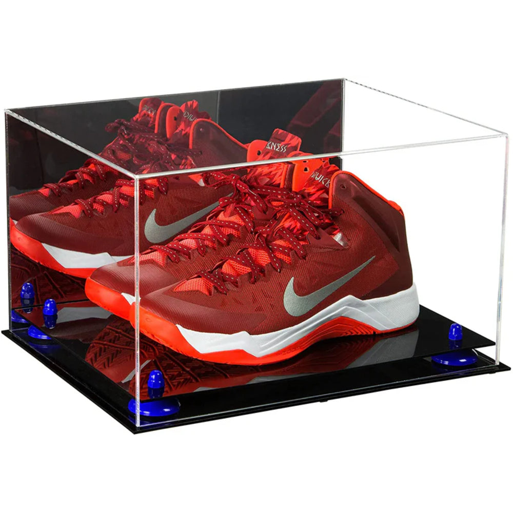 Red Nike basketball shoes in a clear display case with a black base.