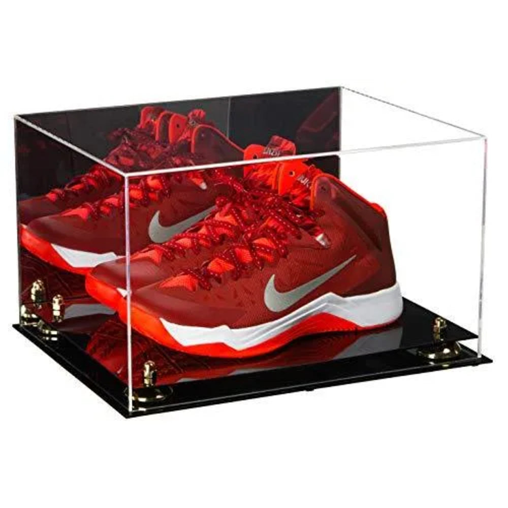 Red sneakers with a white logo in an acrylic display case on a black base.