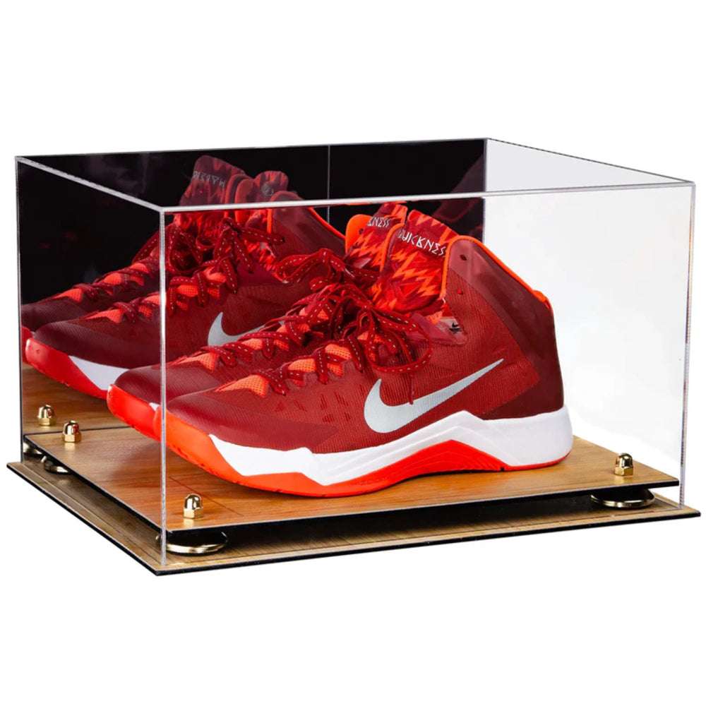 Red Nike sneakers in a clear display case on a wooden base