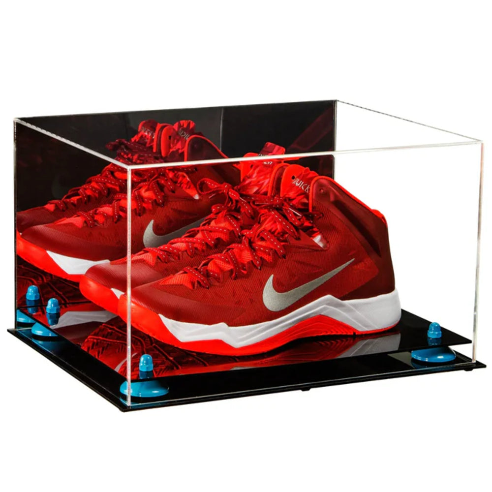 Red Nike basketball shoes in a clear display case on a white background