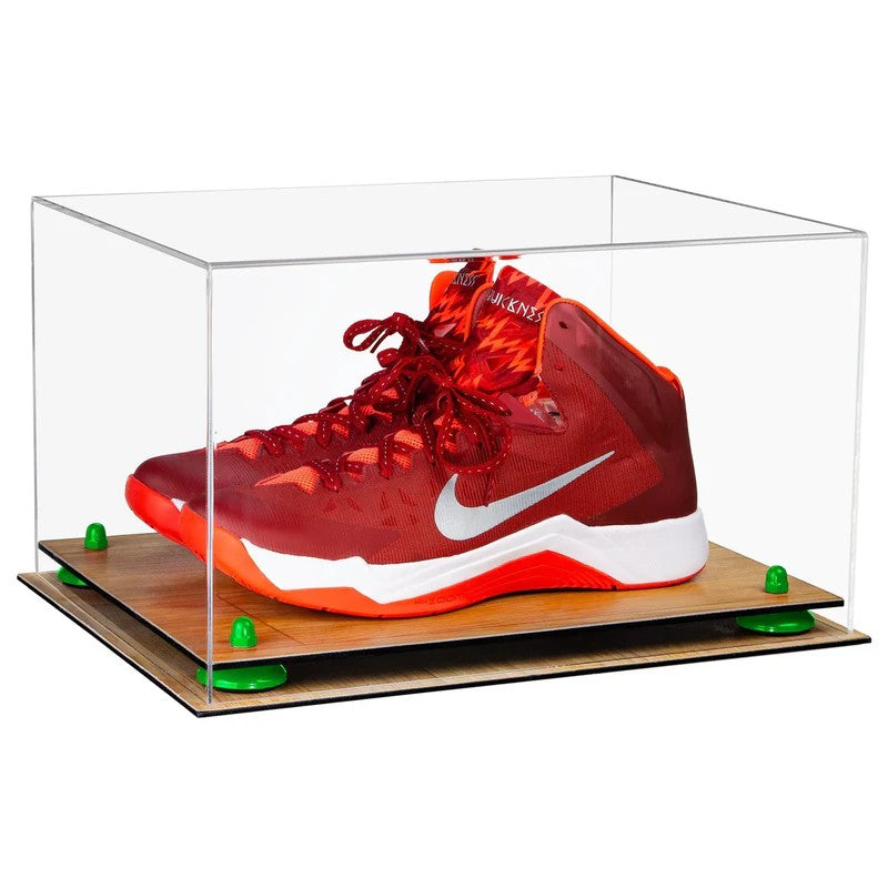 Red sneaker with white swoosh logo in a clear display case on a wooden platform.