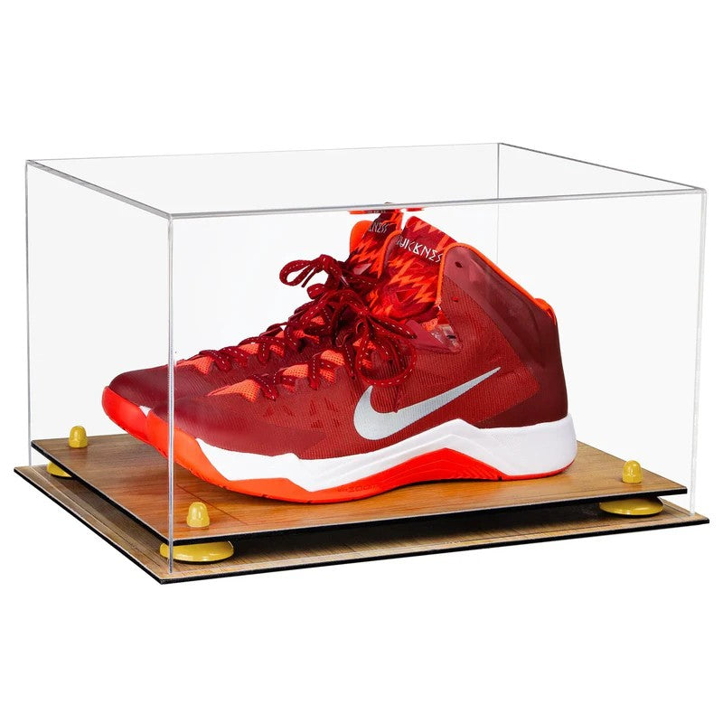 Red sneaker with white swoosh logo in a clear display case on a wooden platform.