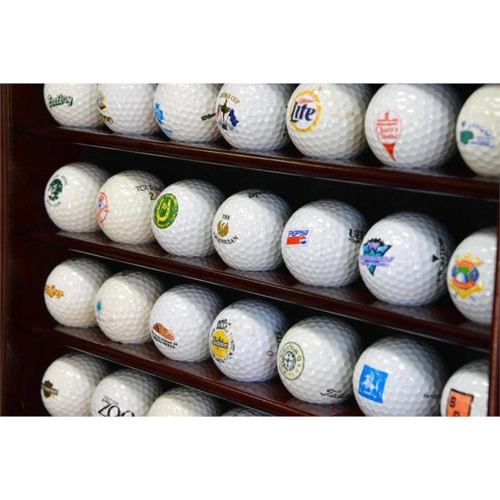 Shelf with various branded golf balls on a white background. Golf ball display case cabinet holder