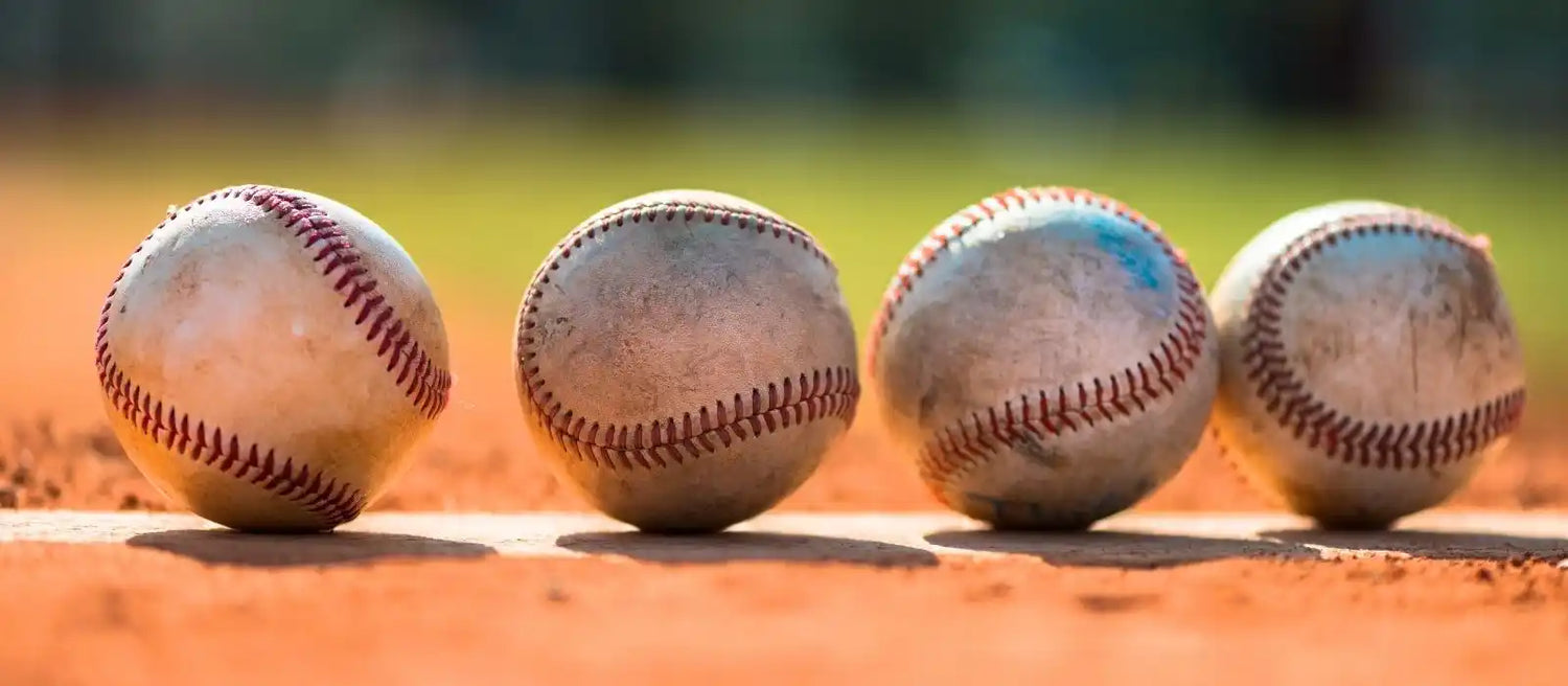 Baseball display cases showcasing autographed MLB baseballs in wall mounted cabinets and acrylic display cubes