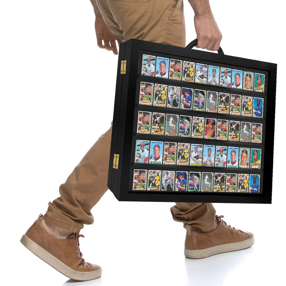 Person holding a black case filled with collectible trading cards on a white background