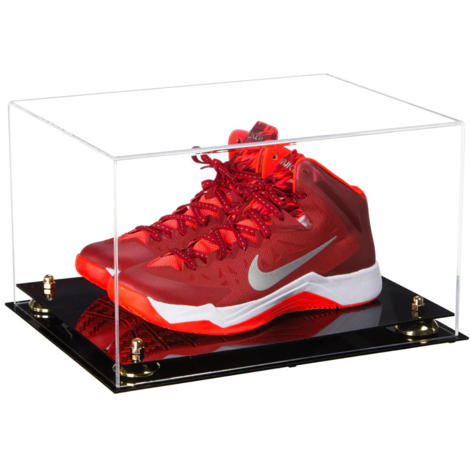 Red sneaker with white swoosh logo in a clear display case on a black base