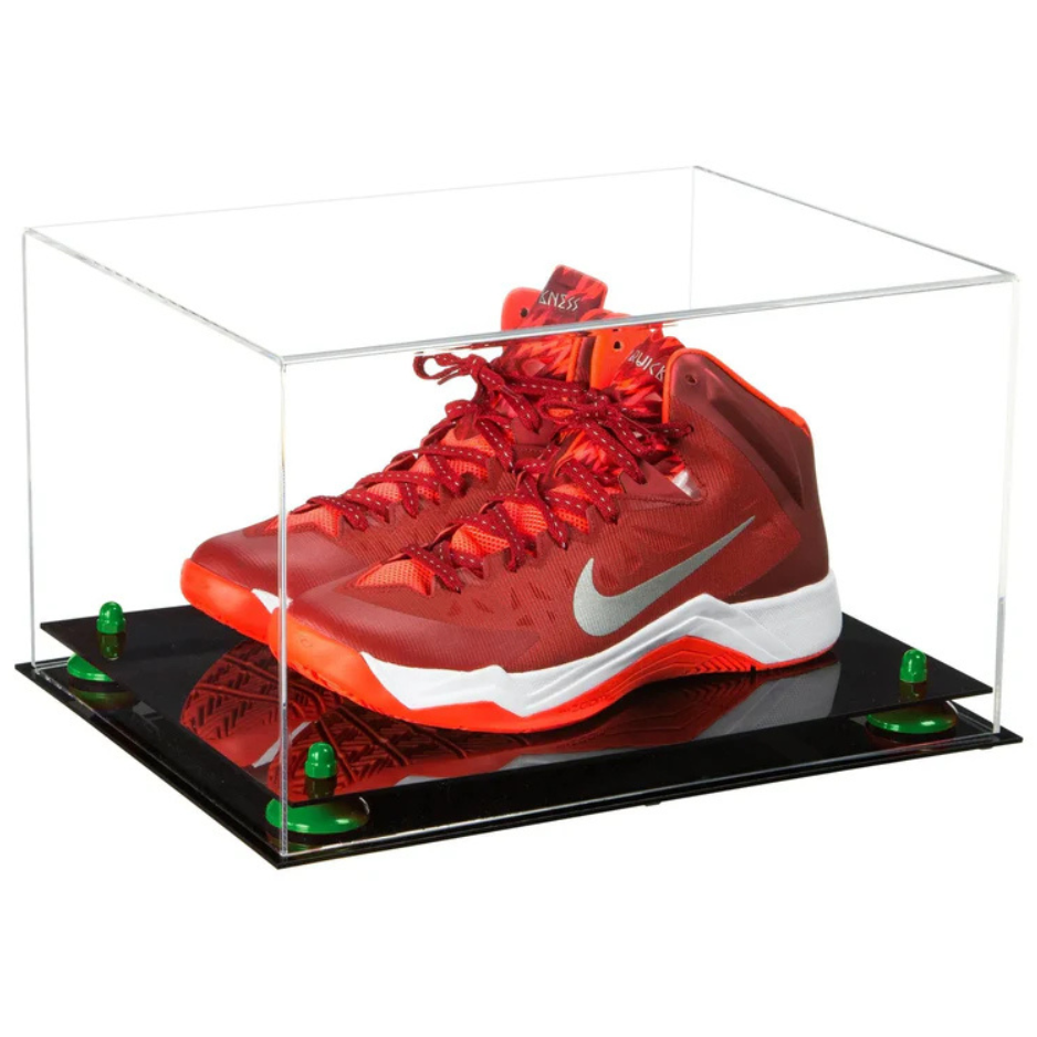 Red Nike basketball shoe in a clear display case on a black platform