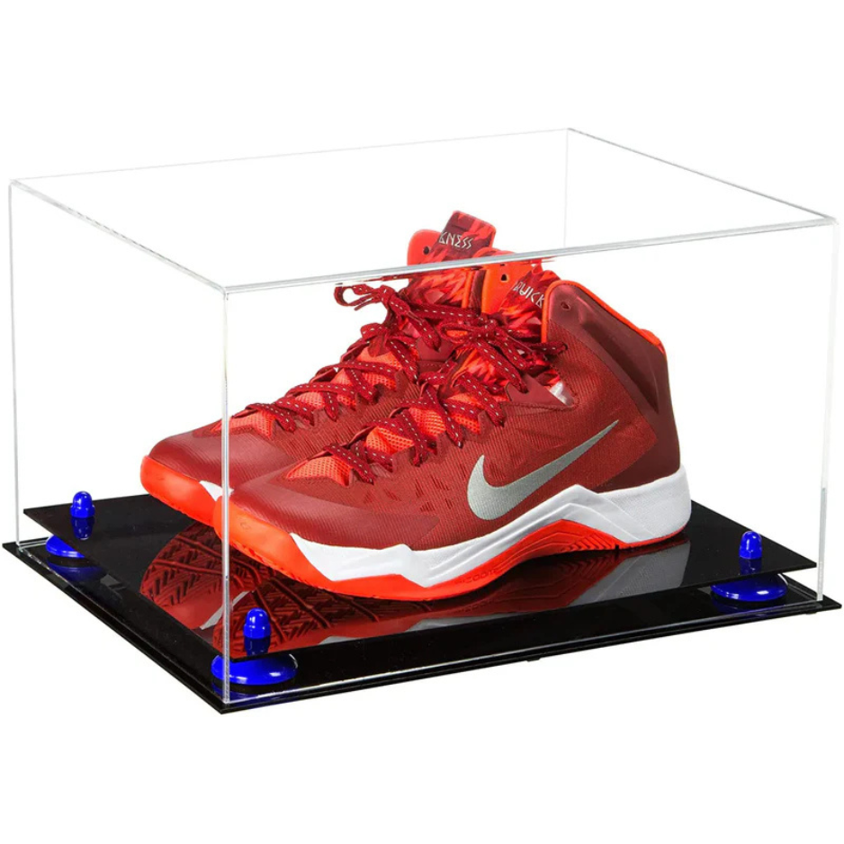 Red Nike basketball shoe in a clear display case on a black platform with blue lights.