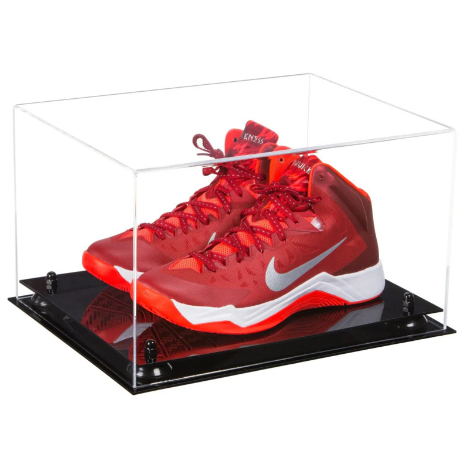 Red sneakers with a white logo in a clear display case on a black platform