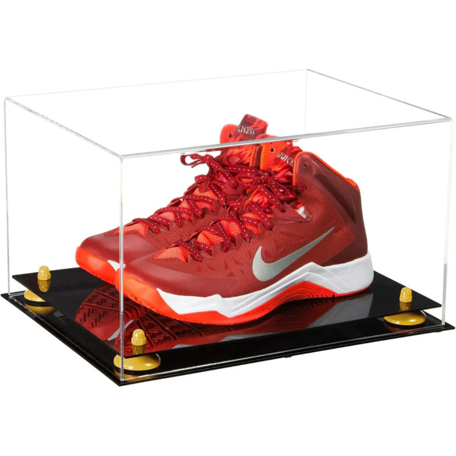 Red Nike basketball shoe in a clear display case on a black platform