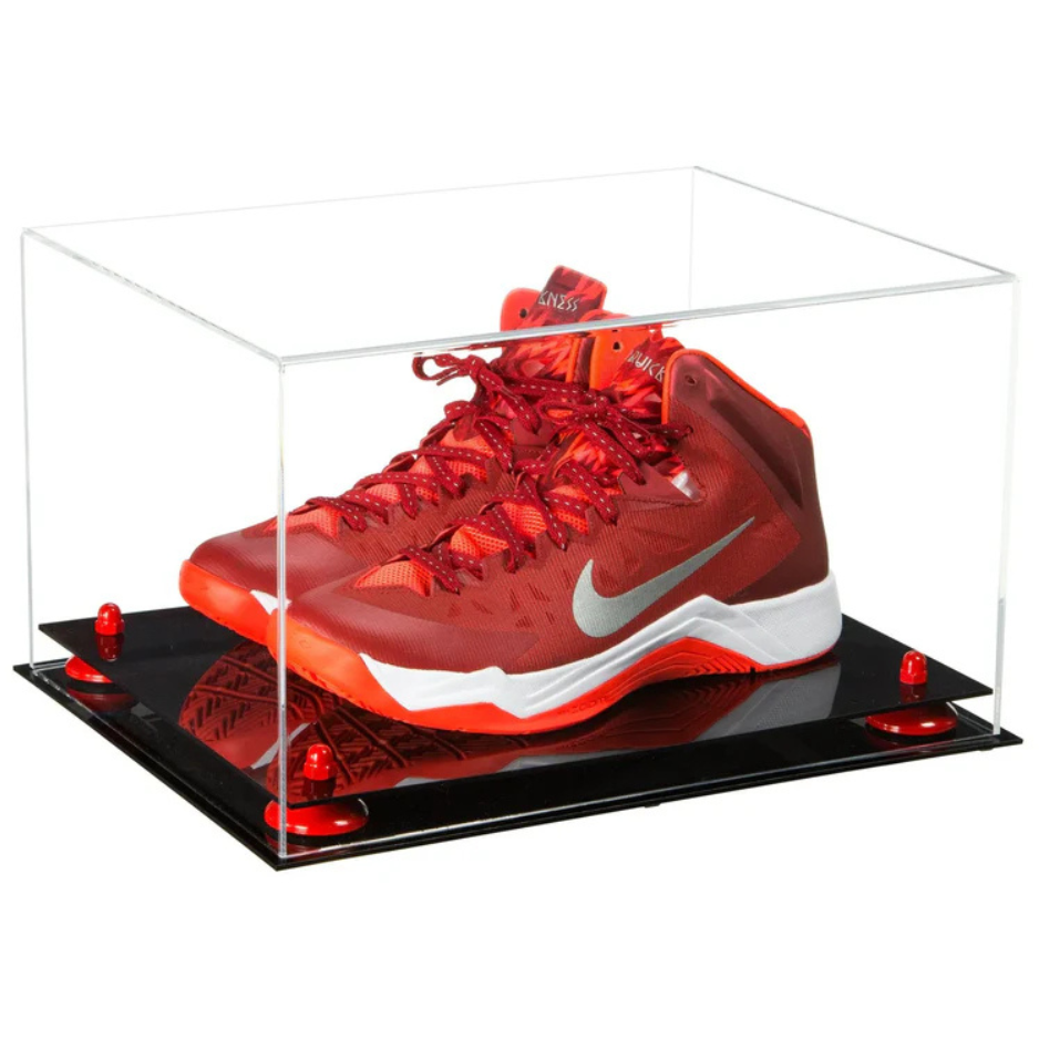 Red Nike sneaker in a clear display case on a black platform