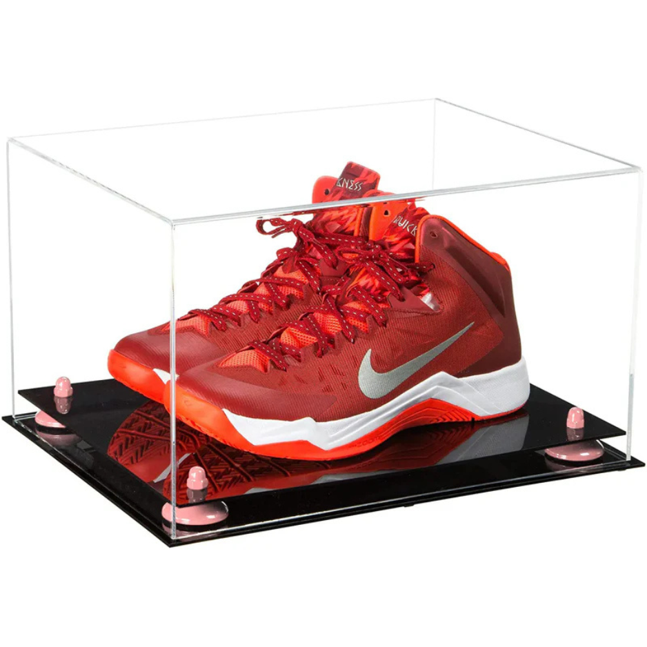 Red Nike basketball shoe in a clear display case on a black platform
