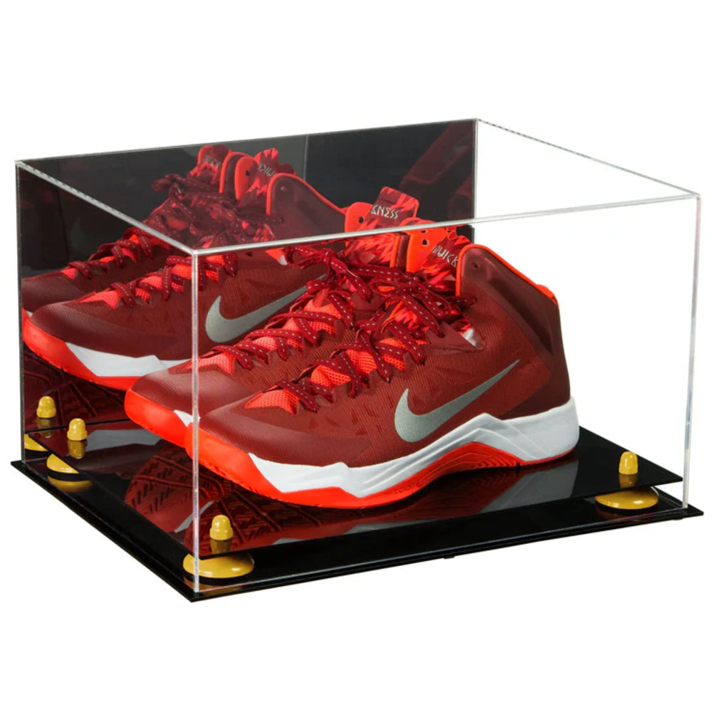 Red Nike basketball shoes in a clear display case on a black base