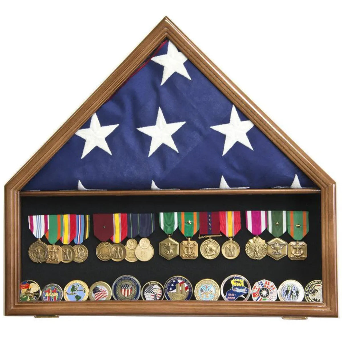 Folded American flag displayed above military medals and challenge coins in a walnut-finish flag and memorabilia case