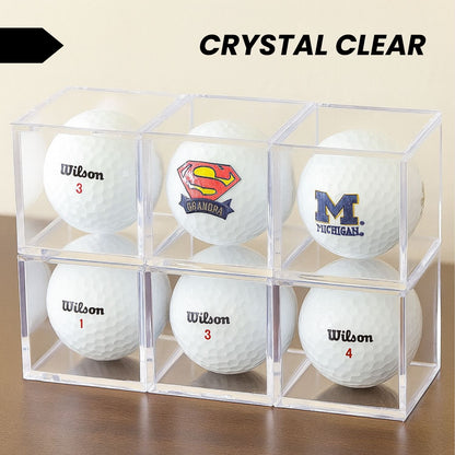 Single golf ball in a clear acrylic cube display case